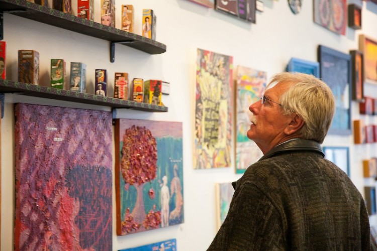 An Art.Downtown. attendee looks at the works displayed at Heartside Gallery.