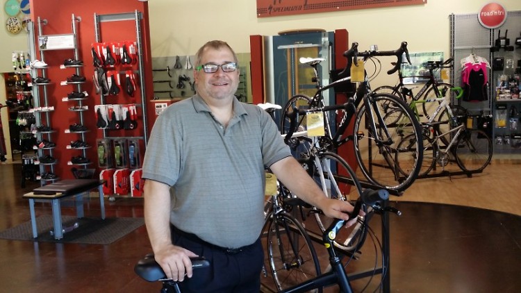 Chris Freeman tries a bike on for size at Village Bike & Fitness