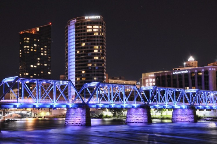 The buildings of downtown Grand Rapids (JW Marriott, Crowe-Horwath, etc.) and the Sixth Street Bridge lit up at night