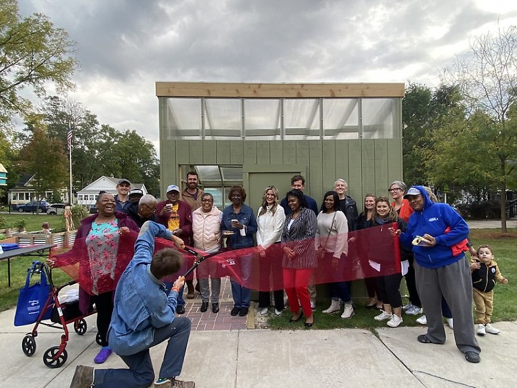 Dwelling Place staff and residents celebrate the Reflections greenhouse with volunteers and AARP of Michigan and Kendall College