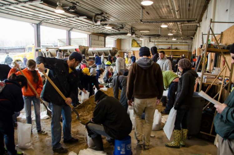 WMEAC volunteers fill sandbags after the 2013 Grand Rapids Flood