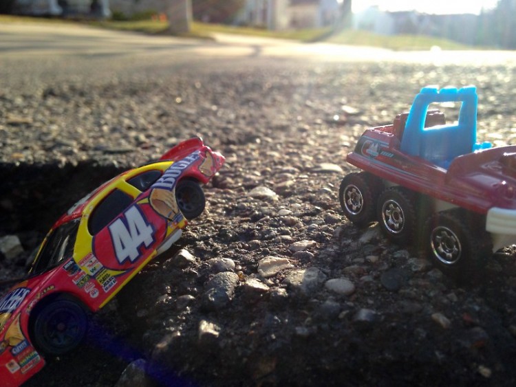 Our managing editor Holly Bechiri used her son's toys and her phone to create scenes in potholes around her neighborhood.