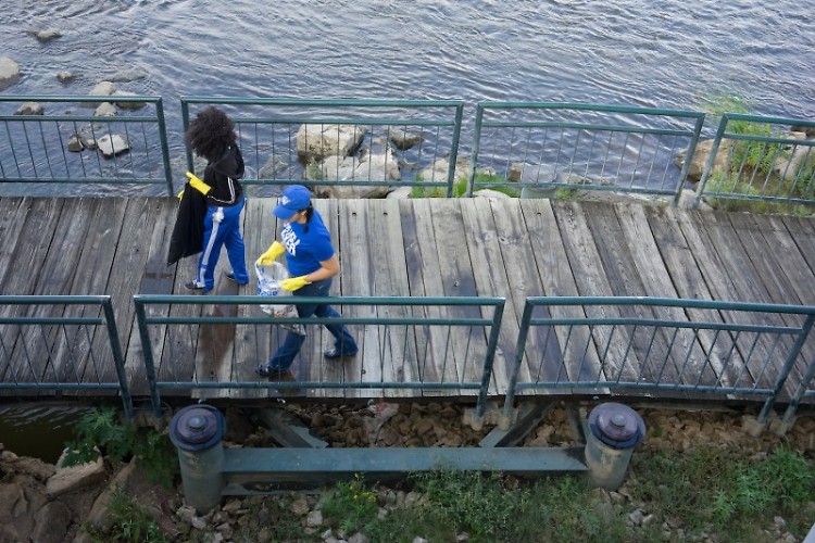 Two volunteers walk along the Grand River at last year's Mayors' Grand River Cleanup