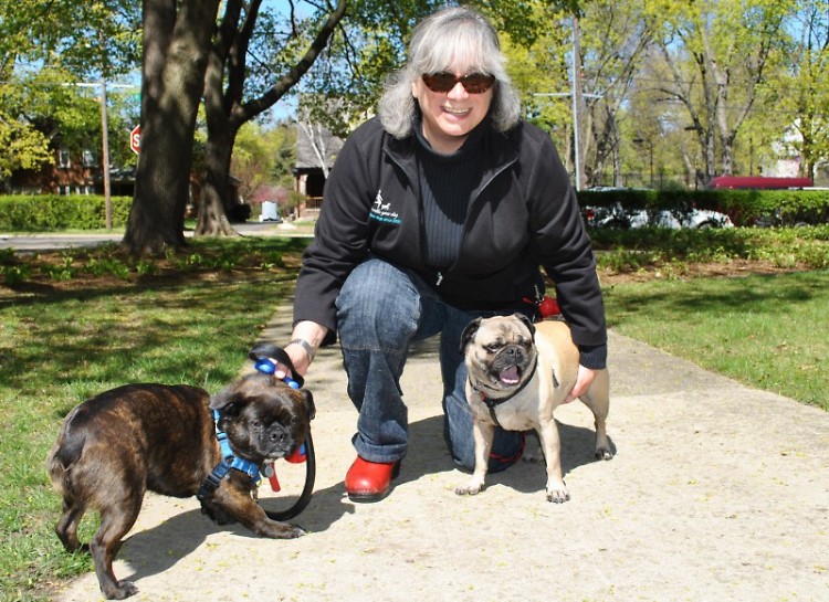 Frances Gentile sits with Phineas, left, and Fergie. She was hired to take them on walks.