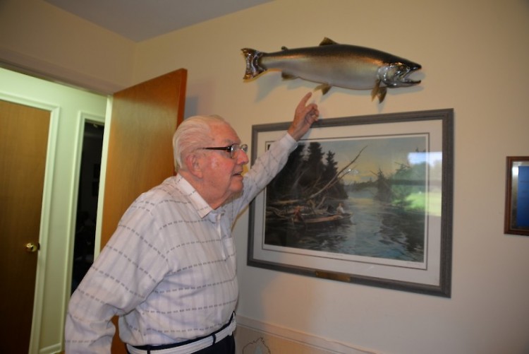 Acclaimed Michigan conservationist Howard Tanner shows off a mounted steelhead trout.