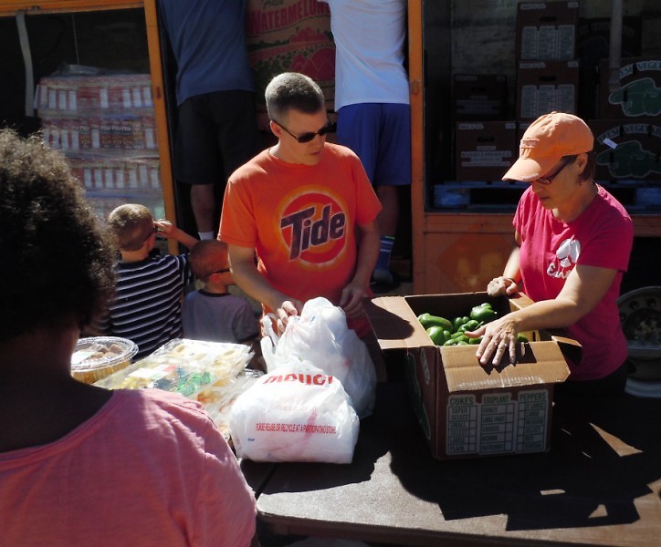 Volunteers from St. Thomas the Apostle set up a Mobile Food Pantry at Congress Elementary School in August.