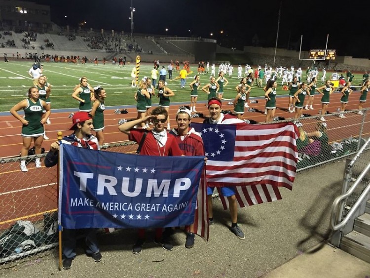 Students from Forest Hills Central displaying a Trump campaign flag and a Betsy Ross flag at a football game at Houseman Field.