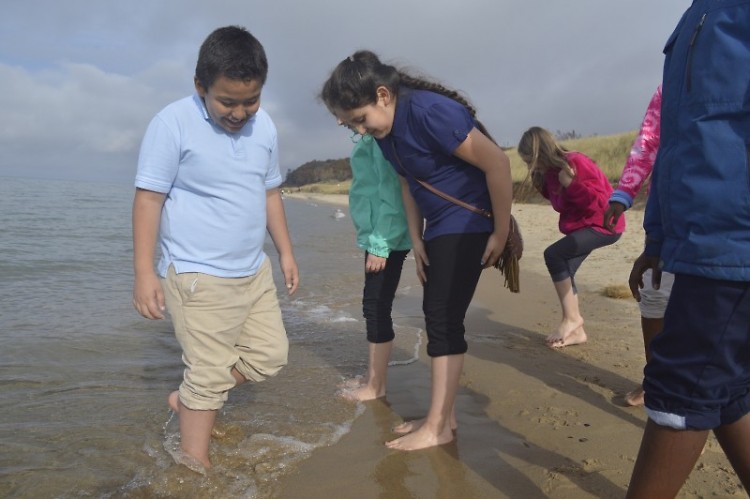 Bravely dipping their feet into the cold water are, left, Alan Ramirez-Becerra and Naudia Radilla-Diego of Stocking Elementary S