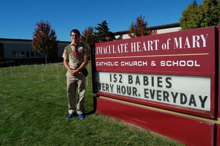 Tom Haley at Immaculate Heart of Mary Catholic Church and School, crosses in background