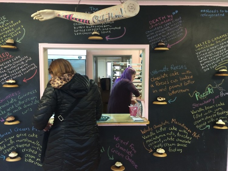 The Salted Cupcake's walk-up window surrounded by the flavors of the day.
