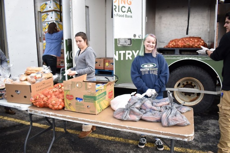 Marissa serves at a Mobile Food Pantry but also receives food for her family. 