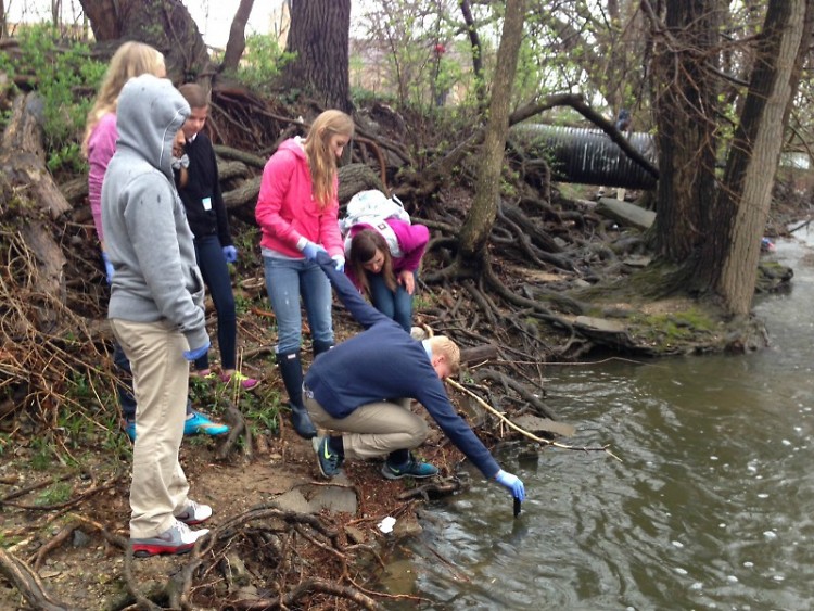 Middle school students collecting data from Plaster Creek