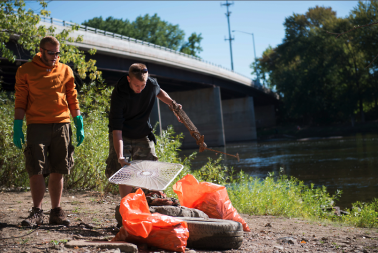 Volunteers work to clean the Grand River