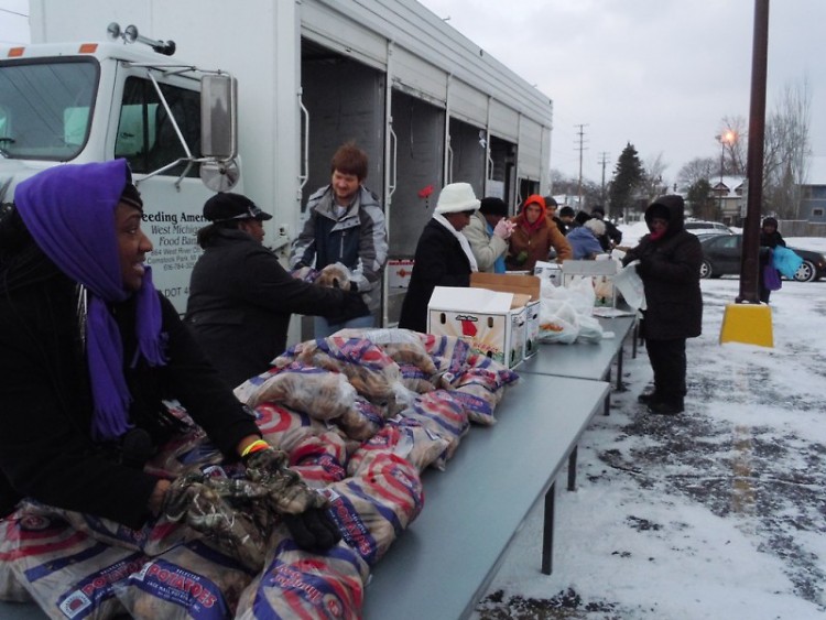 Volunteers unload food at a distribution at Pilgrim Rest Missionary Baptist Church last week.