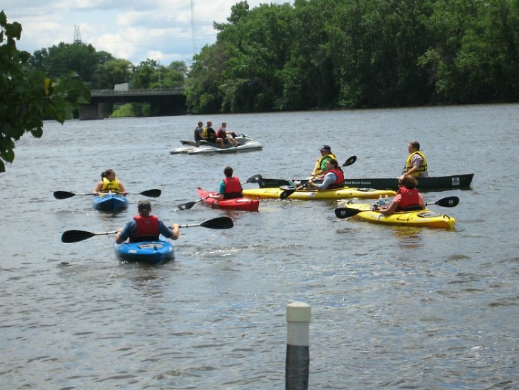 Local citizens kayak in the Grand River with Mayor Heartwell
