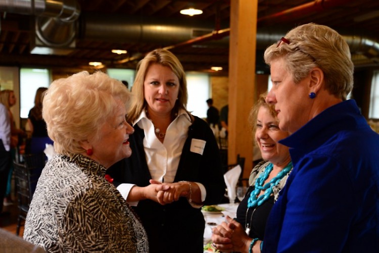 Judge Sara Smolenski, right, talks with guests at the Many Hands Against Hunger fundraising luncheon.