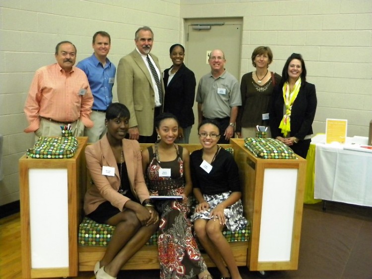 Representatives from Century A&E, GRPS, and United Way's Schools of Hope and Volunteer Center pose with the Reading Corner bench