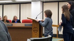 Two children giving speeches at the City Commission meeting in support of banning the use of wild animals for entertainment. 