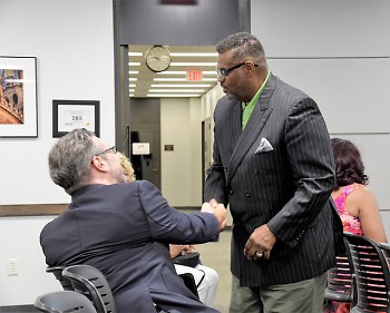 Commissioner Moody shaking hands with a fellow candidate after being appointed to the Grand Rapids Commission  