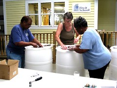Participants learned how to save on water bills and care for the environment at a Fix-It School rain barrel workshop.