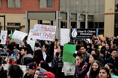 Community members march past César E. Chávez Elementary School while honoring his legacy  