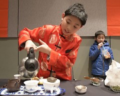 Andrew Wu pours tea he made at the Chinese New Year Celebration