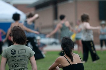 Festival founder Michele Fife (right) looks on as festival-goers try out yoga