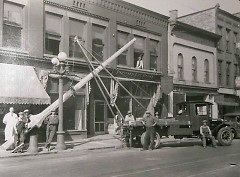 A crew from the street lighting dept. is shown installing a new light on the west side of Division just south of Fulton in 1928.