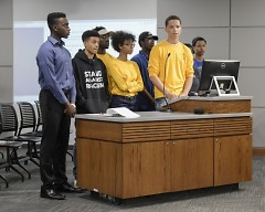 NAACP youth speak to the city commission on policing issues.
