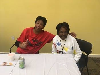 Jones (left, pictured pre-COVID) supports her neighbors with day-to-day encouragement and assistance