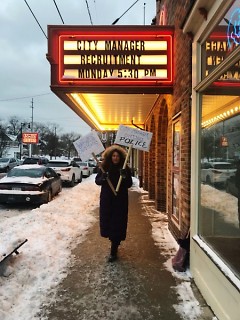 Community member Jasmyne Fuentes outside the theater before the forum raising awareness on issues.