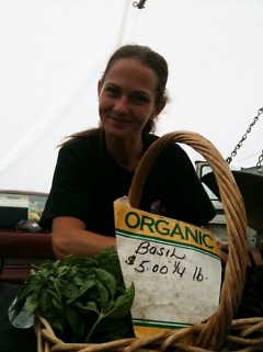 Amanda DeVries (daughter of Farmers' Rose & James) with her basil at the Fulton Market. 