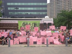 The group who welcomed Milk for Thought with large pink signs.