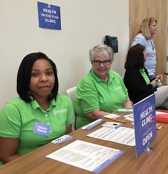 Staffers Candice and Cindy are ready at their "health clinic" table to help participants.