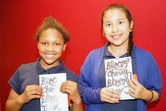 Two young authors hold the latest anthology of youth writing from the Creative Youth Center