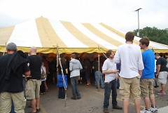 Wood-Aged Beer Festival attendees stand outside the beer tent 