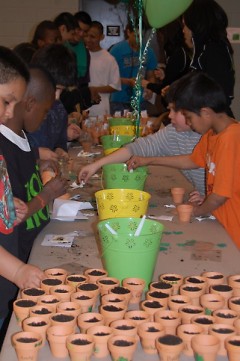 Amway sponsors St. Patrick's Day event including planting shamrocks for good luck.
