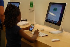Club member enjoys playing at the Apple Store at Woodland Mall.