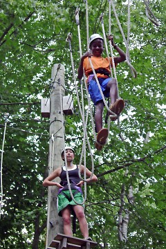 Campers carefully cross the high ropes course located at Camp O'Malley.