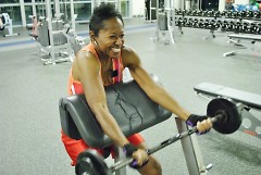 Leah Thomas uses a barbell to work on her biceps at the Kroc Center. 