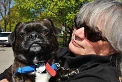 Frances Gentile snuggles with Phineas, one of the dogs she is hired to walk.