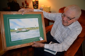 Howard Tanner shows off a painting of the Research Vessel Tanner.