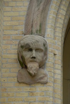 Face on the entranceway at St. James Catholic Church on Bridge Street NW, perhaps one of the city's earliest public art pieces