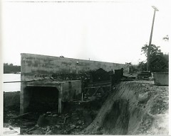 Flood wall construction in 1911. Reportedly, the tunnel at the bottom of the wall was filled with sand to reinforce it.