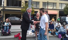 Sam Long and Shawn Feldt shake hands with Mayor George Heartwell.  Cindy Rhodes ETS looks on from behind.