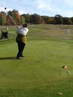 Danielle Davis Shows good form while hitting the ball of the green.