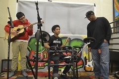 Daniel Arellano, left, and Christopher Garcia, on drums, do some jamming while deejay James Burgen offers pointers
