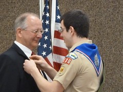 Tom Haley gives his father, Mike Haley, his Eagle Scout Mentor Pin