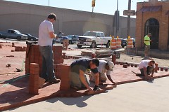 Workers placing bricks on Grandville Avenue