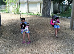 Children reading on swings at the Creative Youth Center
